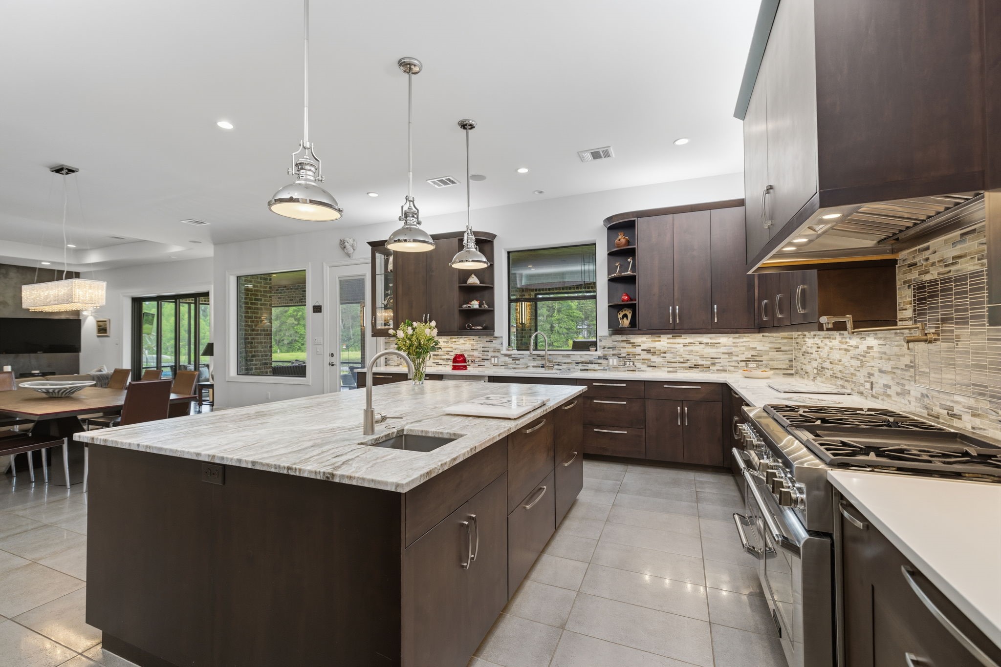 6918 Comanche Bend Montgomery, TX 77316 - Photo 24 of 50 Gas cooking, a convenient pot filler at the wall near the cooktop, and a thoughtfully designed layout make this kitchen truly special. Mrs. Seller did an amazing job planning and designing the space, offering endless storage, abundant counter space, and functionality that any cook in the family will appreciate.