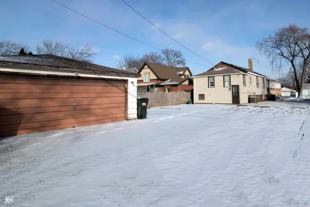 a view of a house with a wooden fence