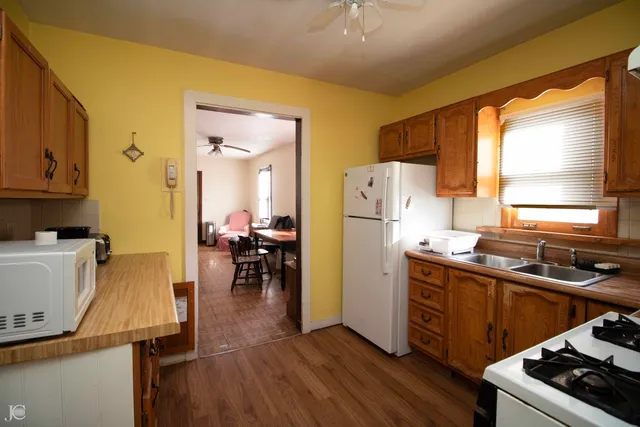 a kitchen with wooden cabinets and stainless steel appliances