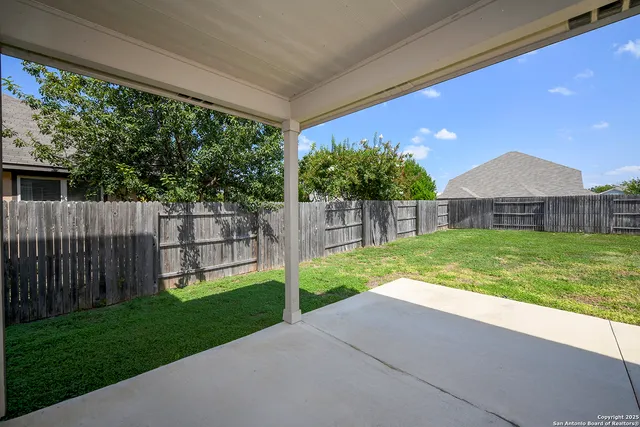 a view of a house with a yard and a garden