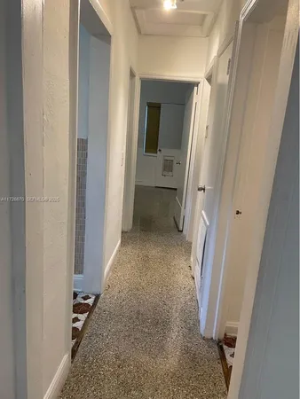 view of a hallway with wooden floor and closet