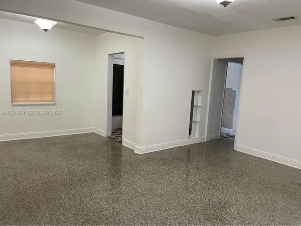 a view of an empty room with a window