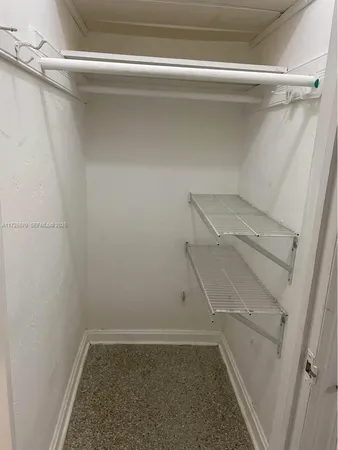 a view of storage and utility room with racks on the wall