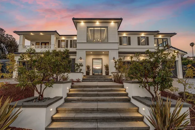 a front view of a house with a garden