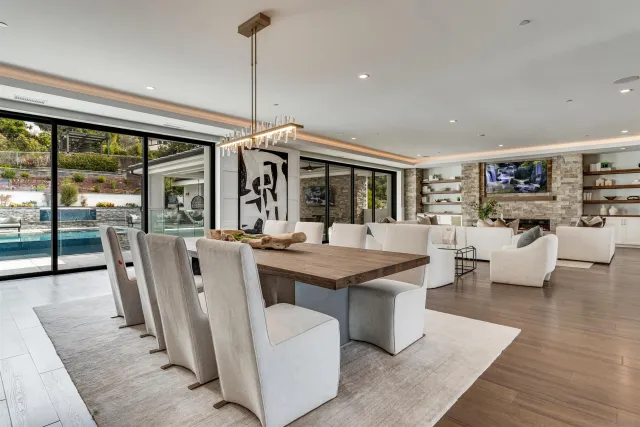 a living room with fireplace furniture and a large window