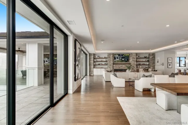 a large kitchen with stainless steel appliances a sink and cabinets