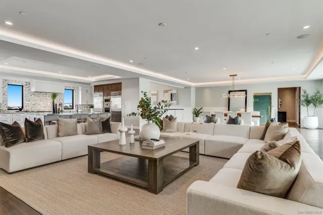 a kitchen with a dining table chairs refrigerator and cabinets