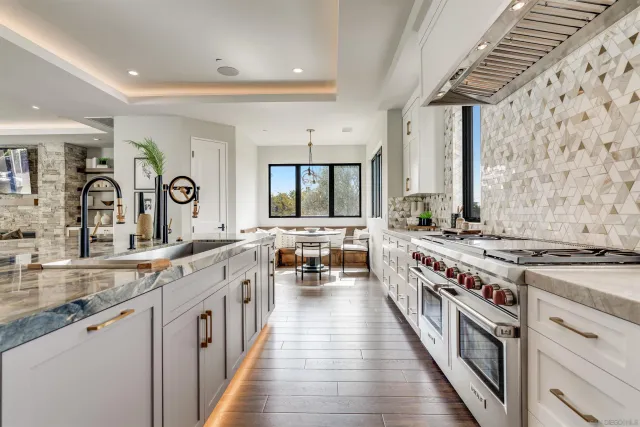 a open kitchen with stainless steel appliances granite countertop a stove a sink and a refrigerator