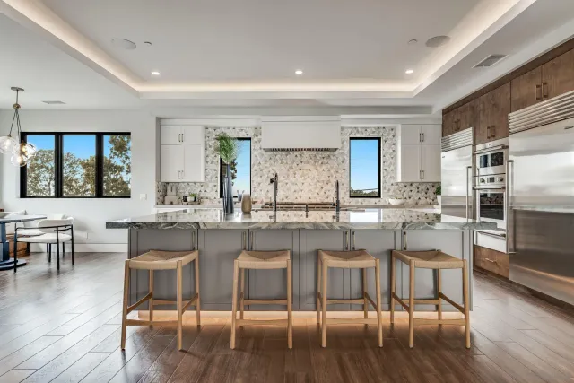 a large white room with a large window and a rug