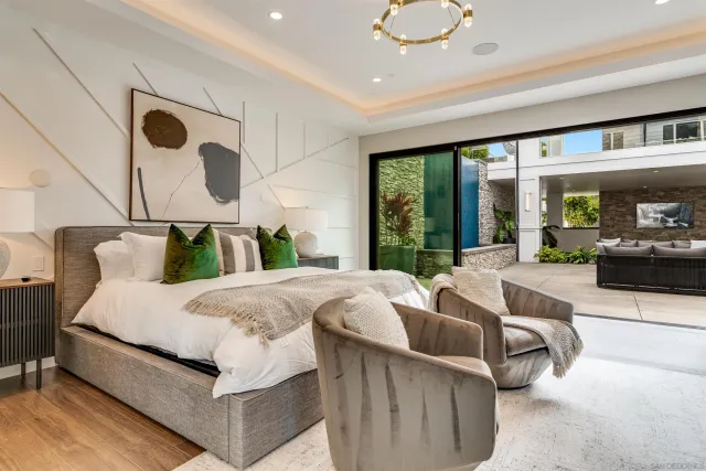 a spacious bedroom with a large bed and a couch