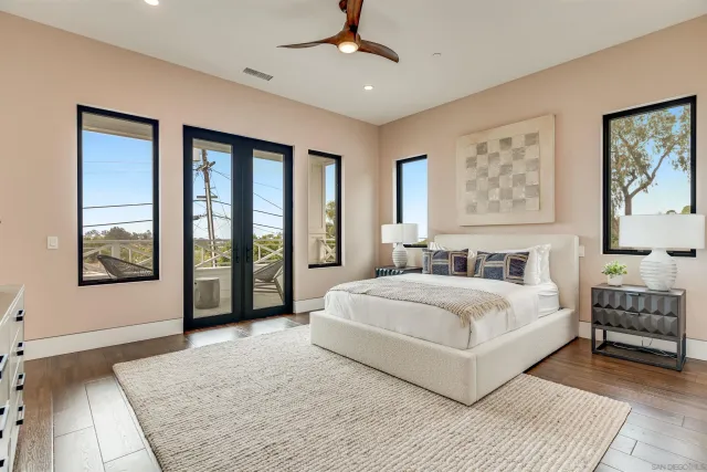 a dining room with furniture a floor to ceiling window and outdoor view