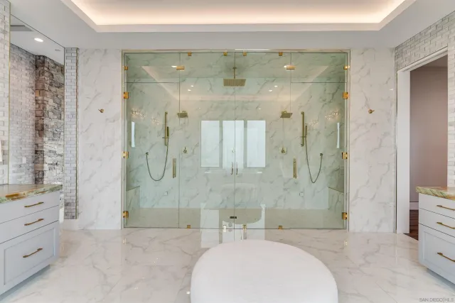 an aerial view of residential houses with outdoor space and parking