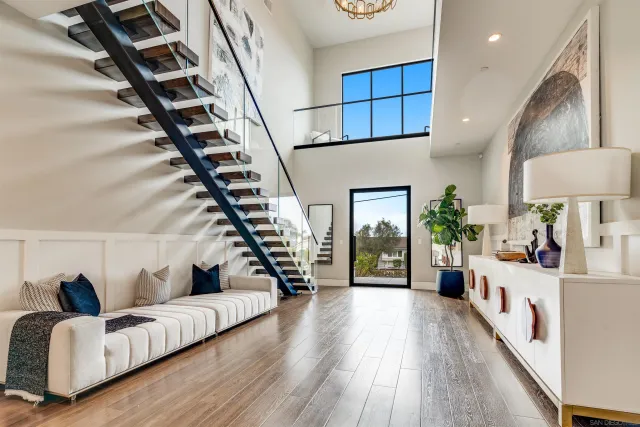 a living room with fireplace furniture and a large window