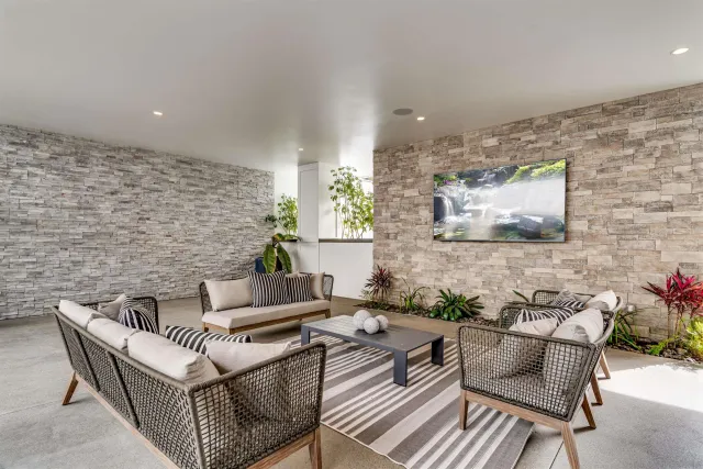a living room with furniture and a potted plant