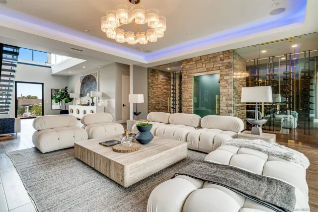 a view of patio with couches table and chairs and potted plants