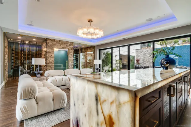 a living room with furniture a rug and a floor to ceiling window