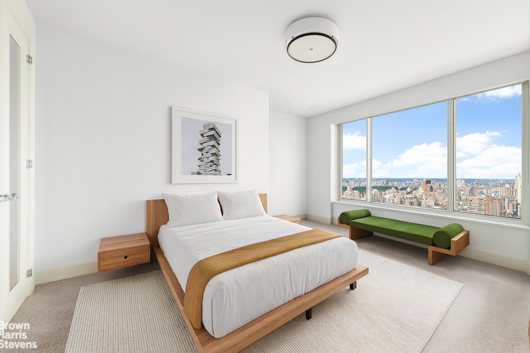 200 East 69th Street, Unit 47 Manhattan, NY 10021 - Photo 17 of 29 a bedroom with a bed couch and window