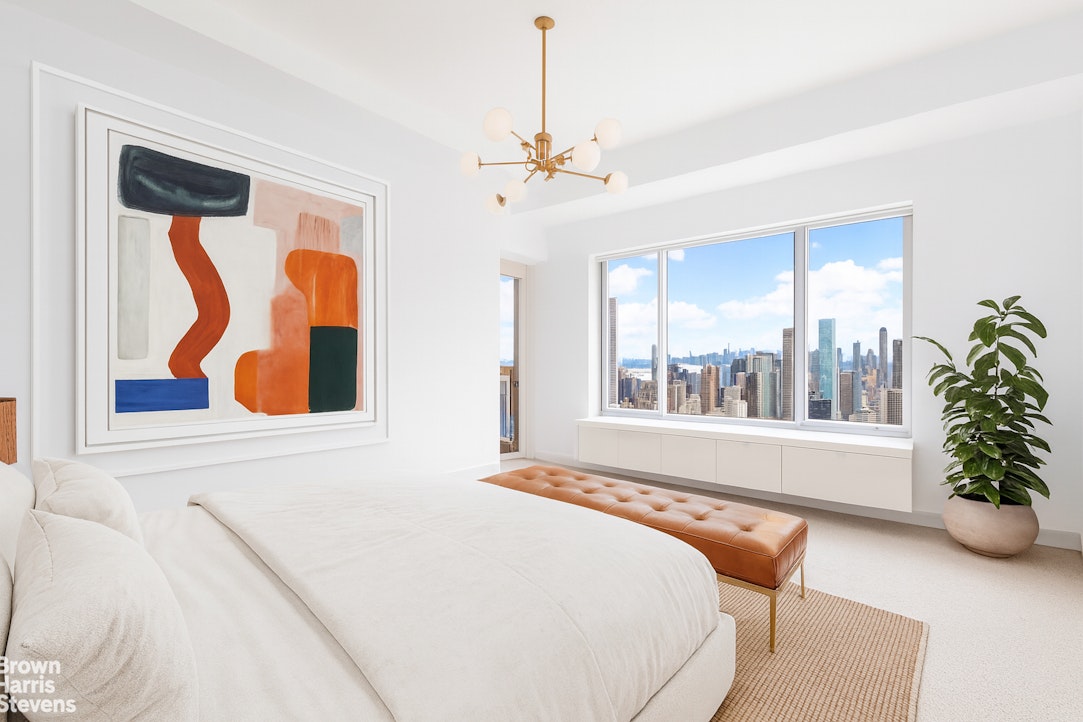 200 East 69th Street, Unit 47 Manhattan, NY 10021 - Photo 19 of 29 a bedroom with furniture and a large window