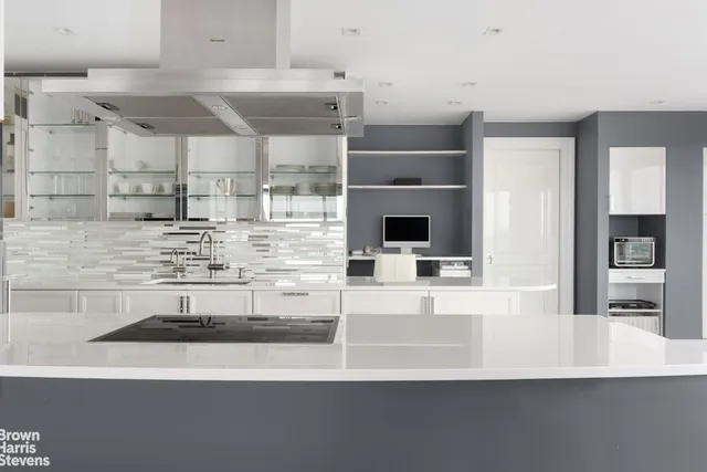 a view of a kitchen with a sink microwave and cabinets