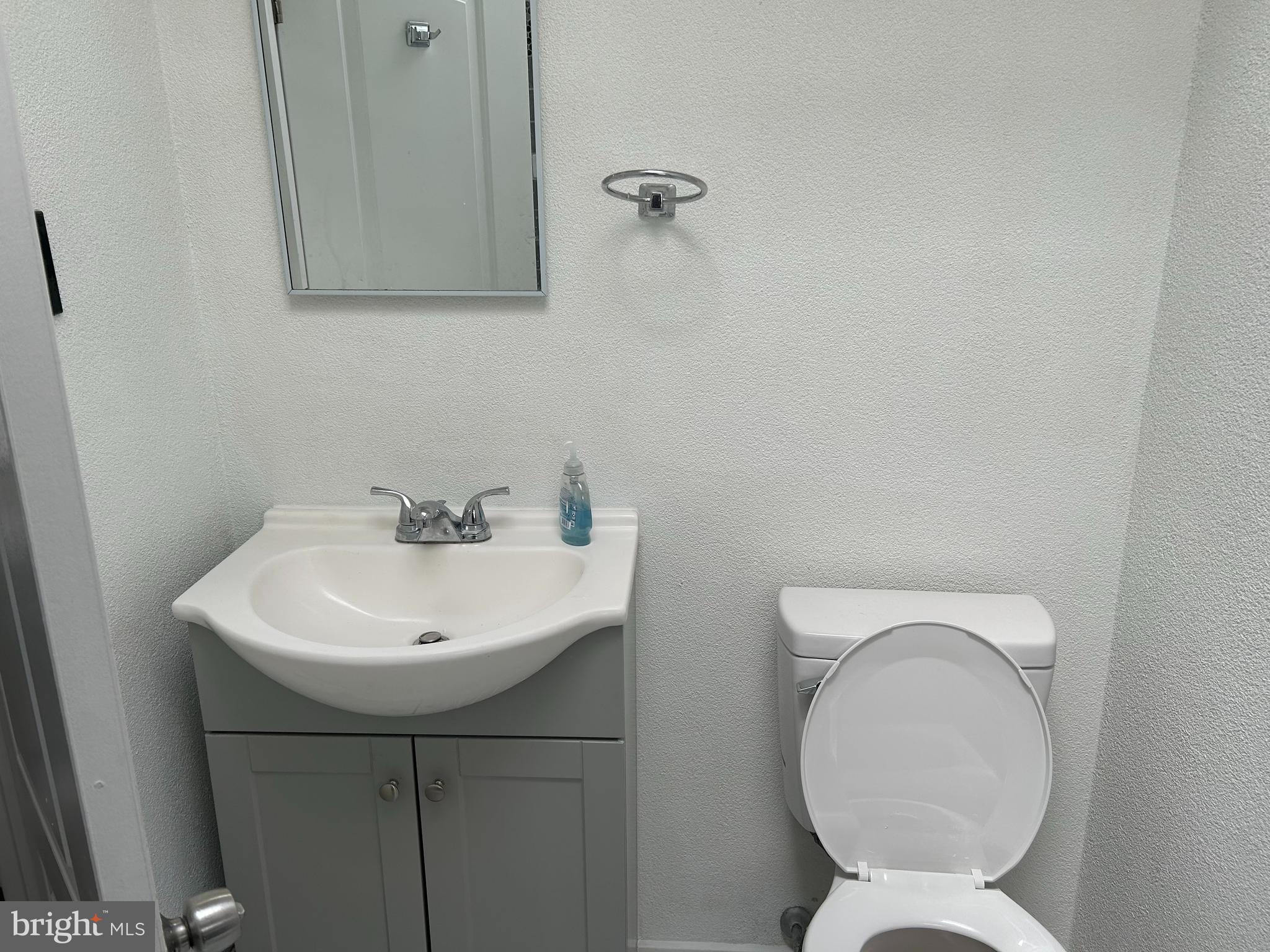 126 Fronefield Avenue Linwood, PA 19061 - Photo 13 of 15 a bathroom with a toilet sink and mirror