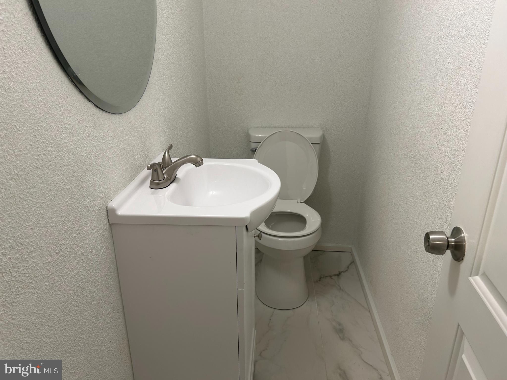 126 Fronefield Avenue Linwood, PA 19061 - Photo 14 of 15 a bathroom with a sink toilet and a mirror