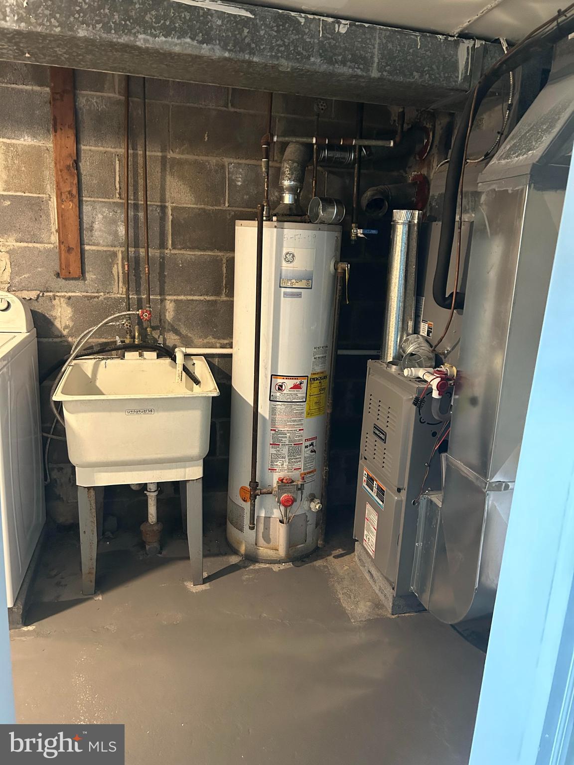 126 Fronefield Avenue Linwood, PA 19061 - Photo 2 of 15 a room with water heater and a refrigerator