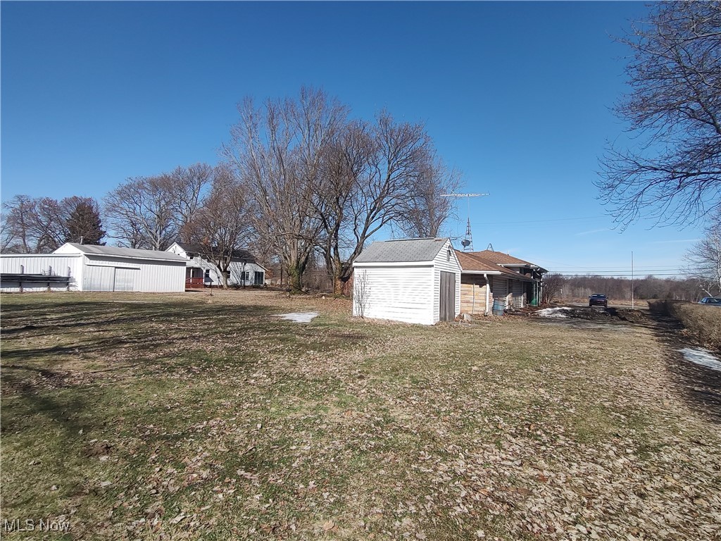 5704 Middle Ridge Road Madison, OH 44057 - Photo 45 of 50 View of yard featuring an outbuilding and a storage unit