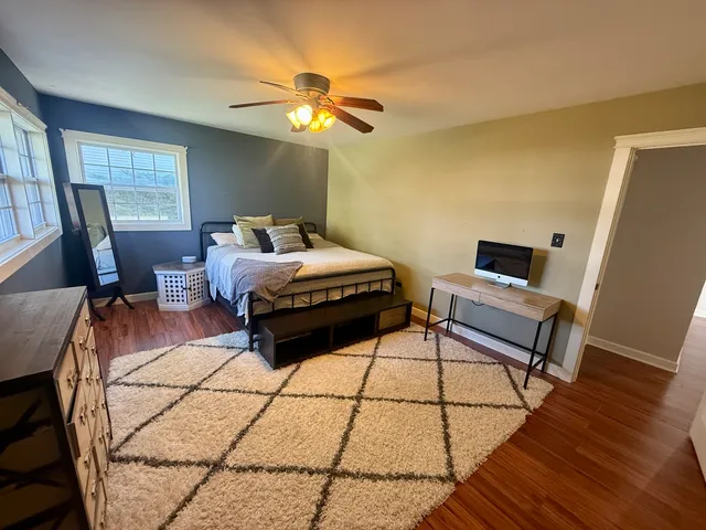 a spacious bedroom with a bed and a chandelier