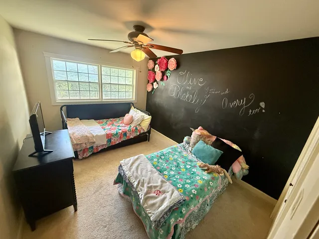 a bedroom with two beds and a window