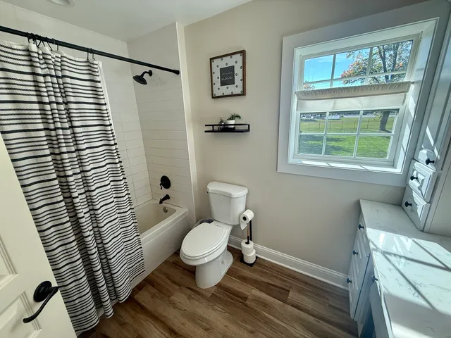 a bathroom with a toilet a sink and a shower