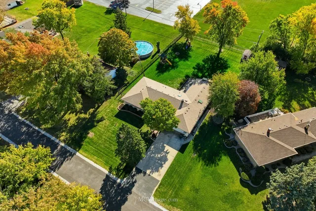 an aerial view of a house with a yard