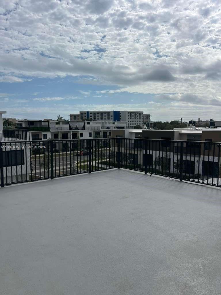 14561 Southwest 261st Terrace, Unit 1 Homestead, FL 33032 - Photo 11 of 13 a view of a balcony with city