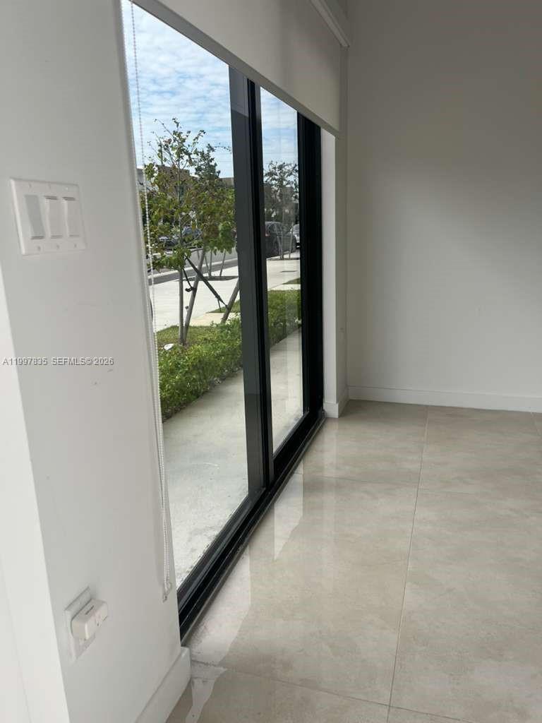 14561 Southwest 261st Terrace, Unit 1 Homestead, FL 33032 - Photo 2 of 13 a view of a room with a large window