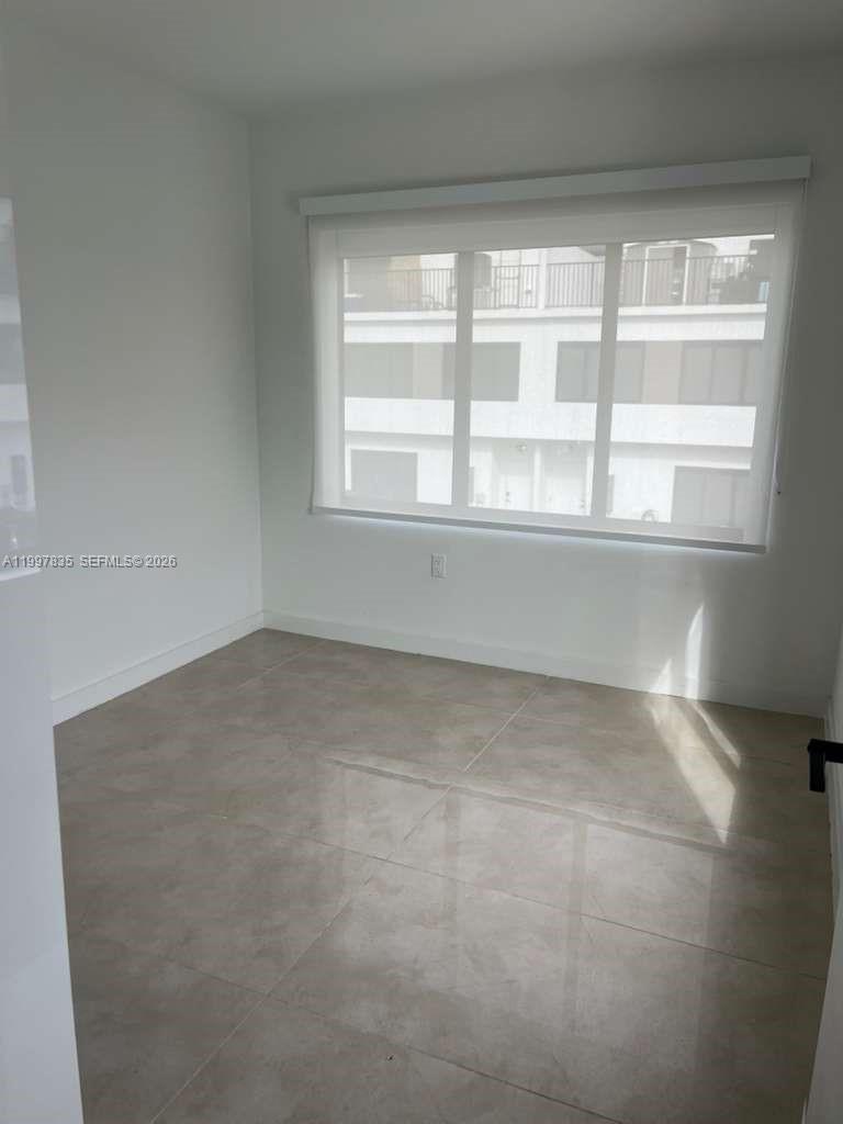 14561 Southwest 261st Terrace, Unit 1 Homestead, FL 33032 - Photo 5 of 13 a view of empty room with window