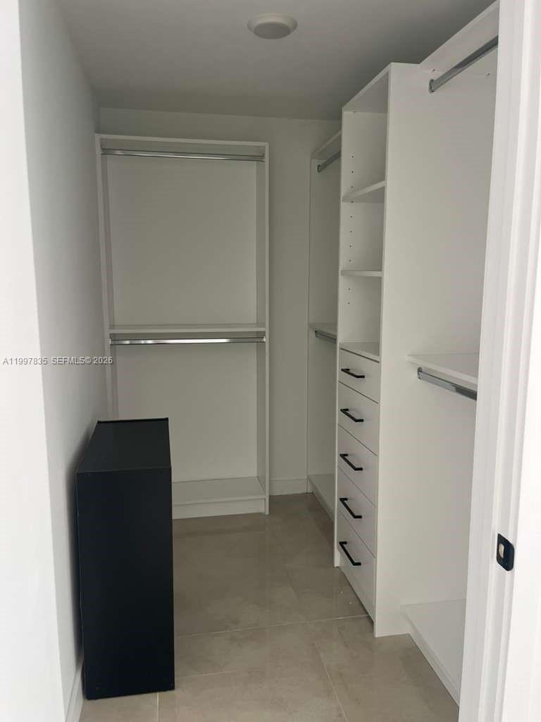 14561 Southwest 261st Terrace, Unit 1 Homestead, FL 33032 - Photo 9 of 13 a view of walk in closet with empty racks