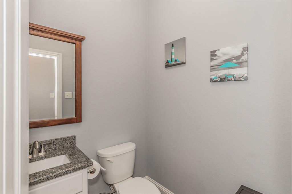 1818 Ebbtide Lane Dallas, TX 75224 - Photo 21 of 33 a white toilet sitting next to a bathroom sink