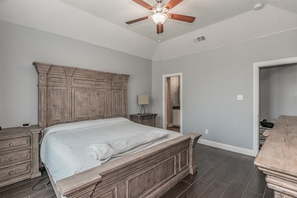 1818 Ebbtide Lane Dallas, TX 75224 - Photo 23 of 33 a bedroom with a bed and a chandelier
