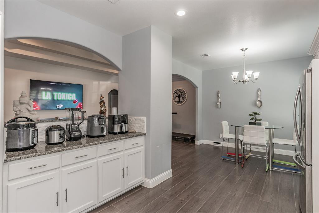1818 Ebbtide Lane Dallas, TX 75224 - Photo 10 of 33 a kitchen with sink cabinets and dining table