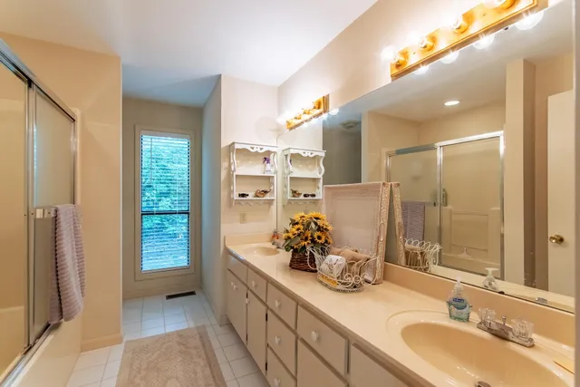 a bathroom with a double vanity sink and a mirror