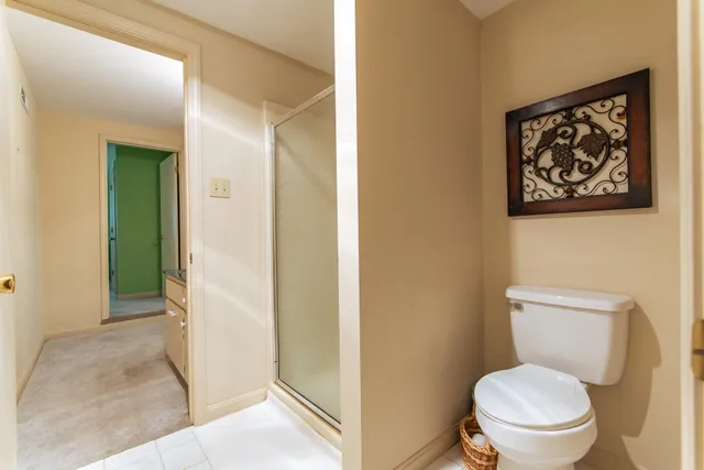 a bathroom with a toilet and a shower