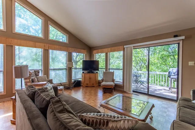 a living room with furniture and large windows