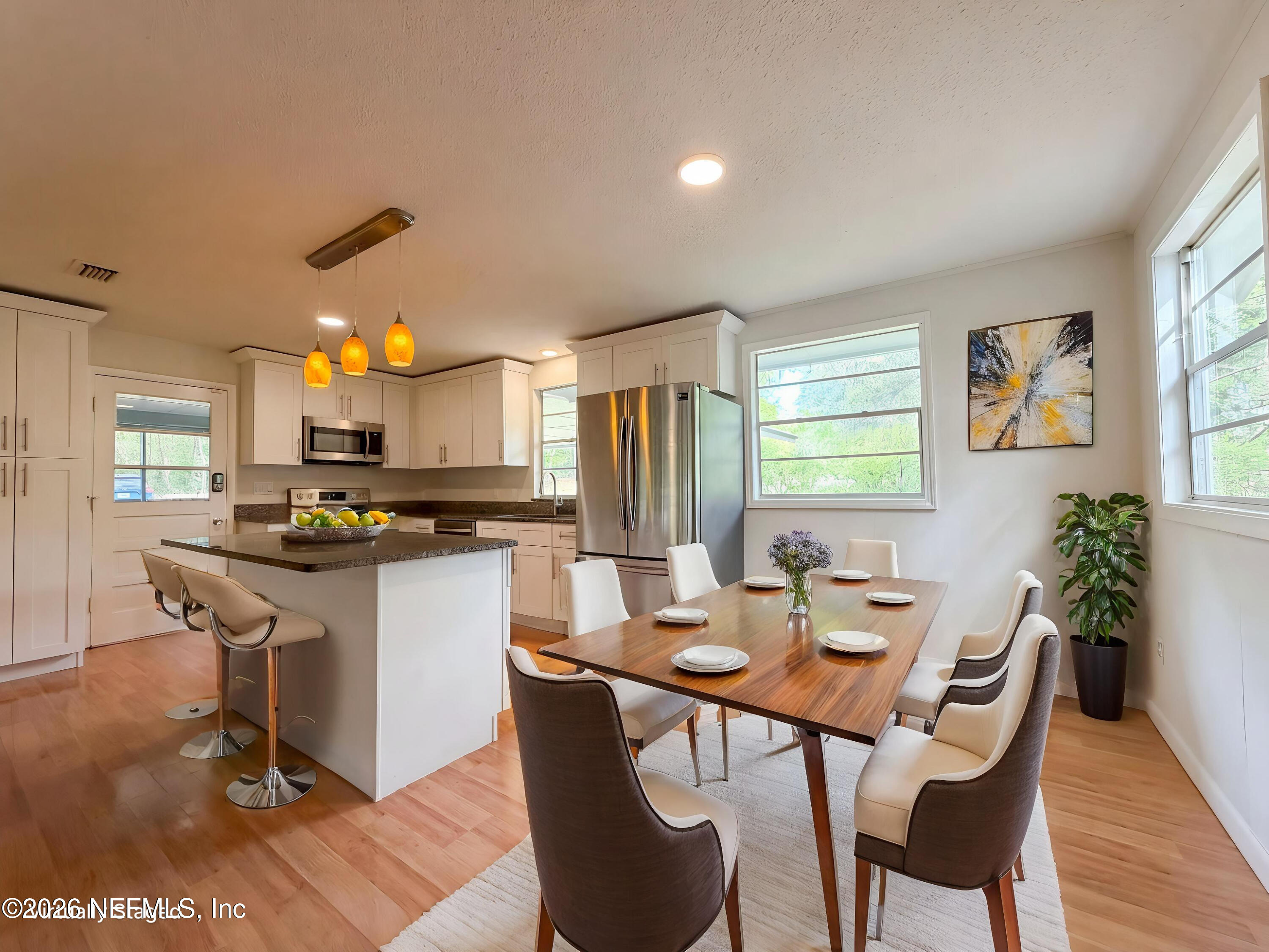 6917 Gatorbone Road Keystone Heights, FL 32656 - Photo 7 of 24 a view of a dining room with furniture and wooden floor