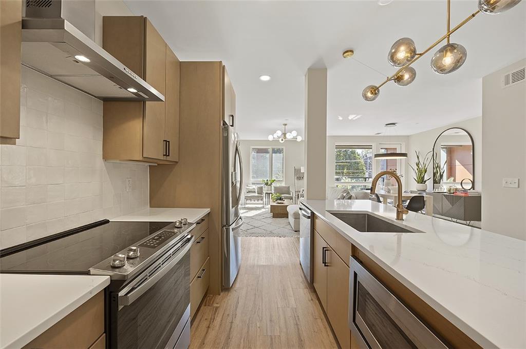 3725 Butler Street, Unit 302 Pittsburgh, PA 15201 - Photo 12 of 44 a kitchen with a sink appliances and cabinets