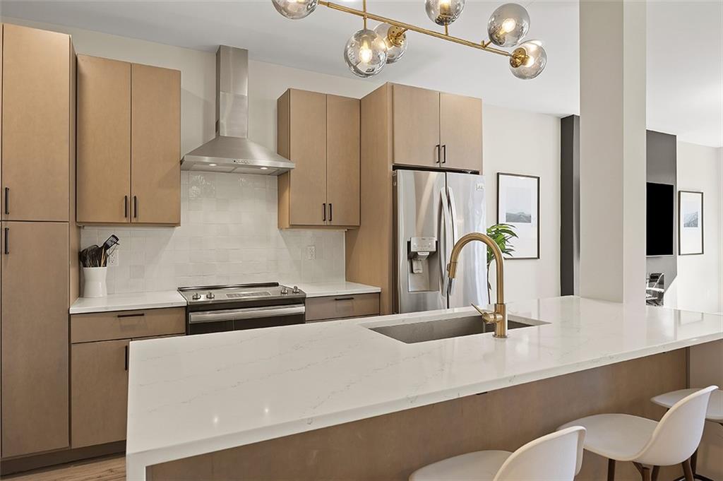 3725 Butler Street, Unit 302 Pittsburgh, PA 15201 - Photo 13 of 44 a kitchen with stainless steel appliances a sink and a refrigerator