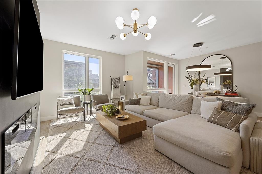 3725 Butler Street, Unit 302 Pittsburgh, PA 15201 - Photo 16 of 44 a living room with furniture fireplace and a flat screen tv