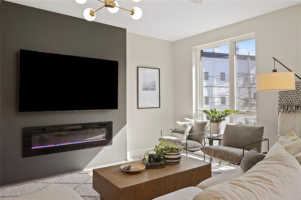 3725 Butler Street, Unit 302 Pittsburgh, PA 15201 - Photo 18 of 44 a living room with furniture and a flat screen tv