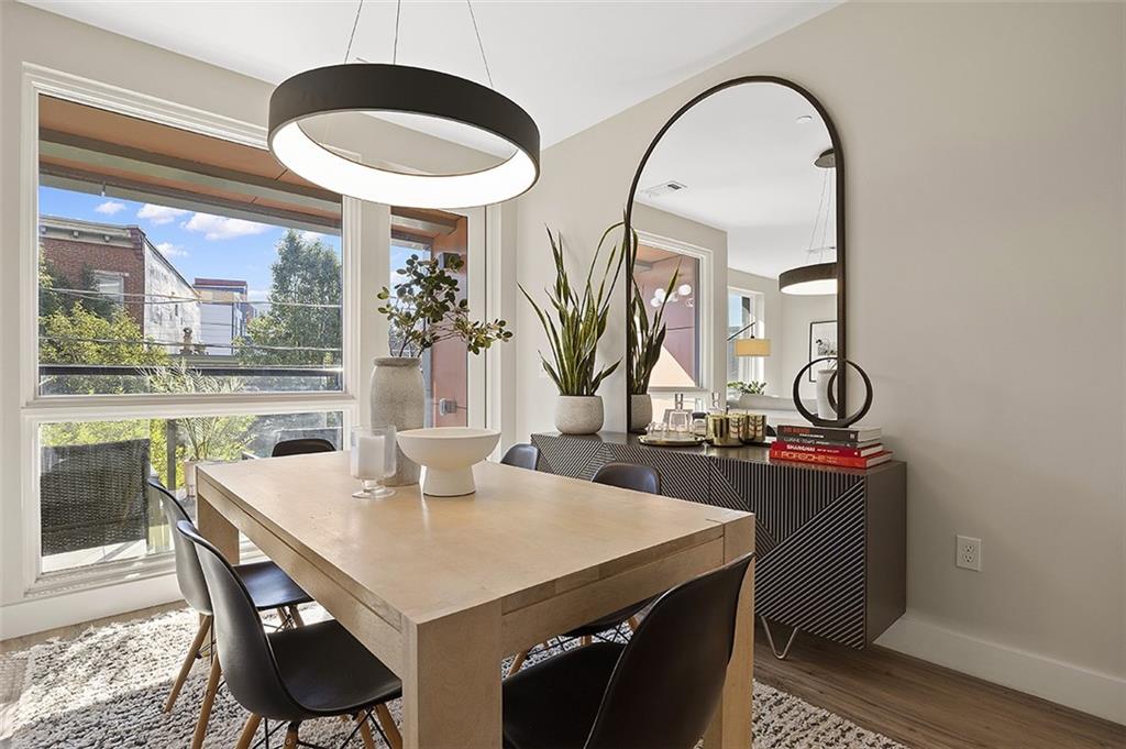 3725 Butler Street, Unit 302 Pittsburgh, PA 15201 - Photo 20 of 44 a view of a dining room with furniture window and wooden floor