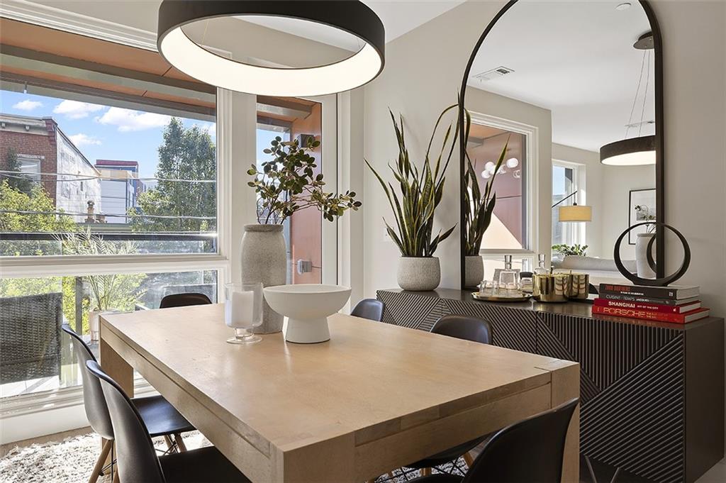 3725 Butler Street, Unit 302 Pittsburgh, PA 15201 - Photo 21 of 44 a view of a dining room with furniture window and outside view