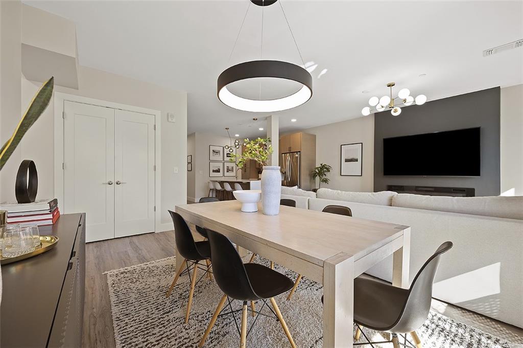 3725 Butler Street, Unit 302 Pittsburgh, PA 15201 - Photo 22 of 44 a view of a dining room with furniture and wooden floor