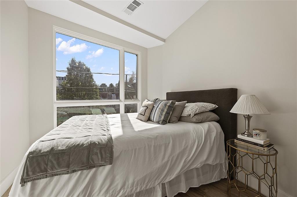 3725 Butler Street, Unit 302 Pittsburgh, PA 15201 - Photo 24 of 44 a bedroom with a bed and a lamp next to a window
